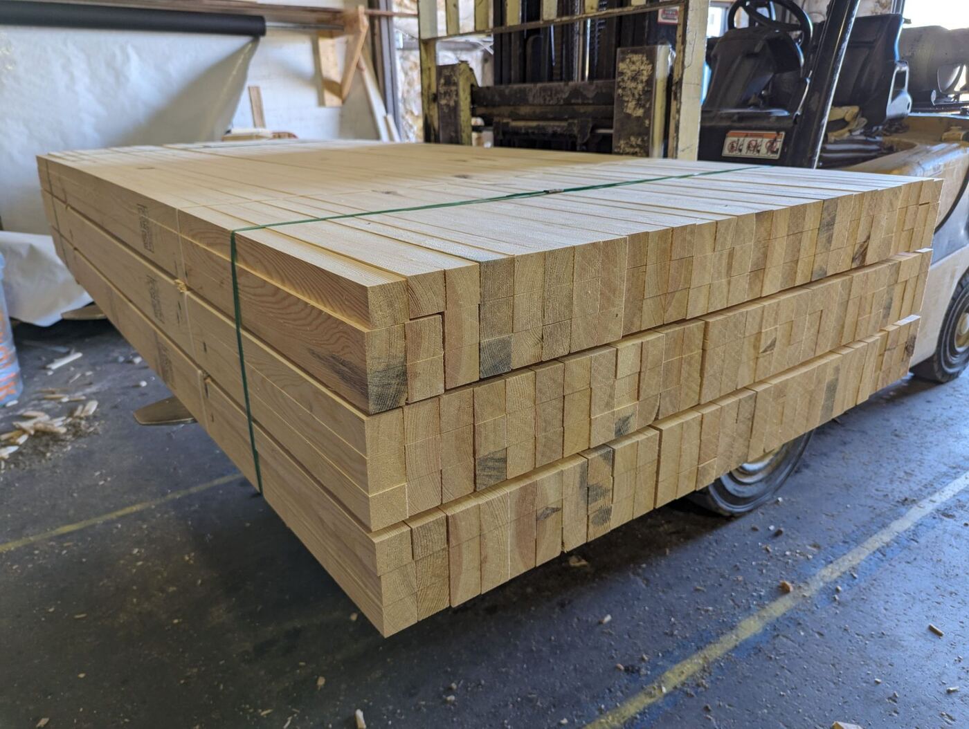 Banded bundles of freshly cut wood stakes.